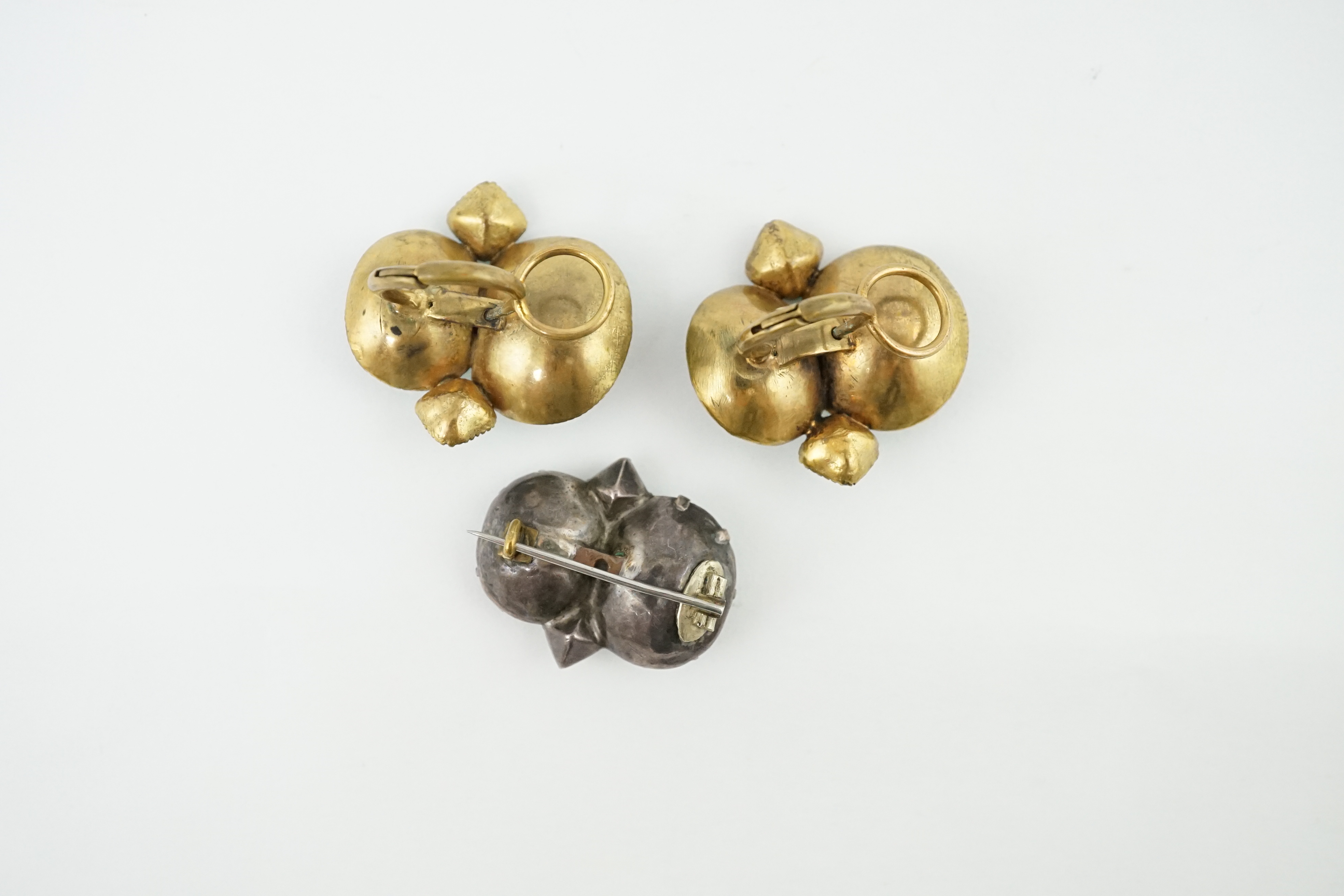 A rare pair of 18th century 'Queen Anne' gilt metal and foil backed paste ear clips with original fittings and a similar two colour paste set brooch